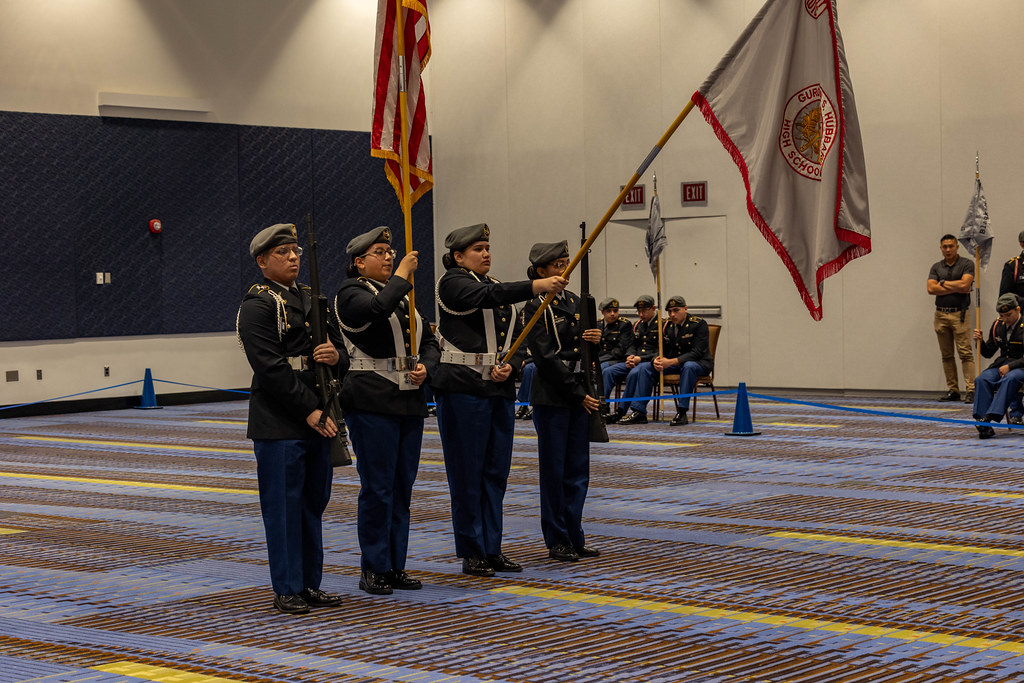 JROTC kadetleri kapalı salon tören alanında bayrak muhafızlığı yapıyor