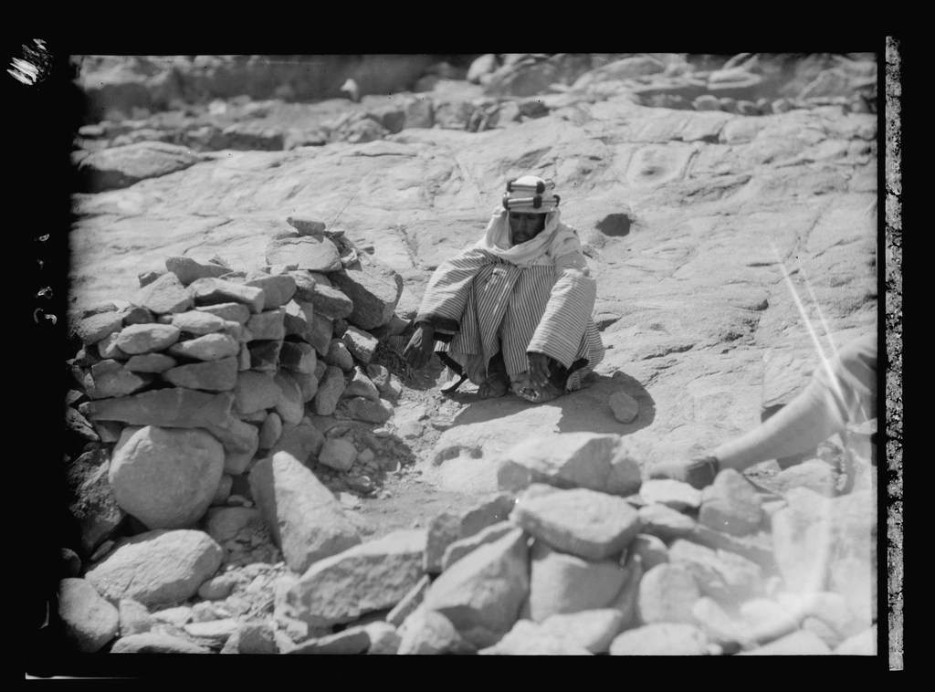Kayalık Arazide Taşlar Arasında Oturan Geleneksel Bedevi, Siyah Beyaz