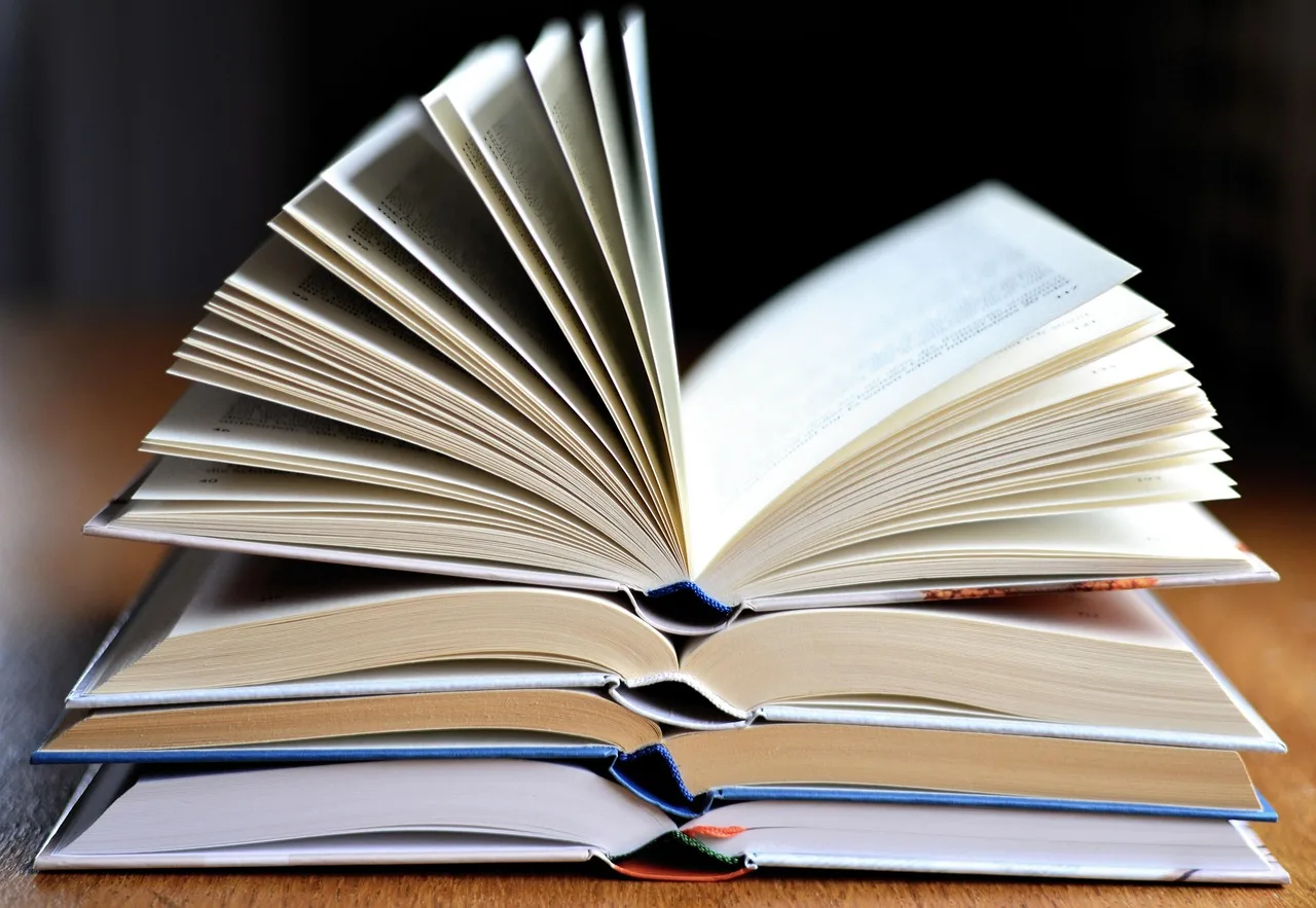 Kitap yığını ve açık sayfalar - öğrenme temalı fotoğraf