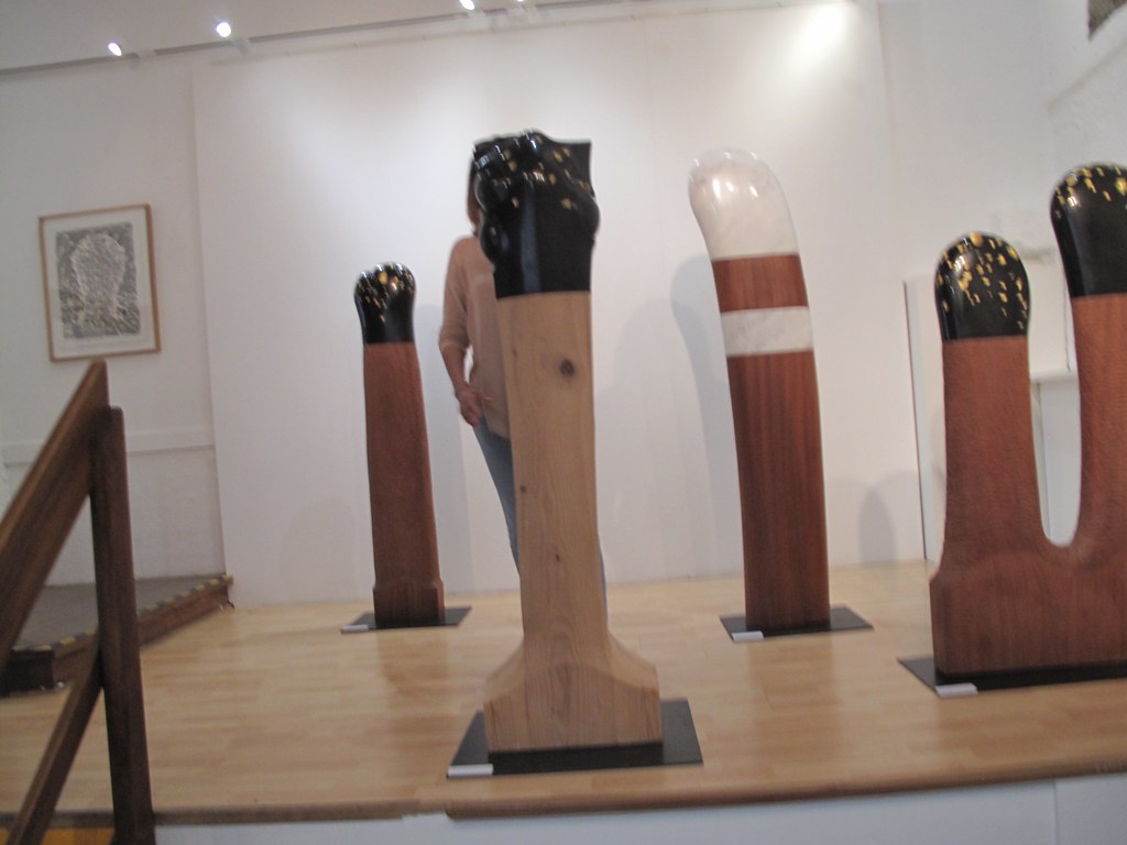 Modern sanat galerisinde sergilenen ahşap heykeller ve minimalist salon atmosferi