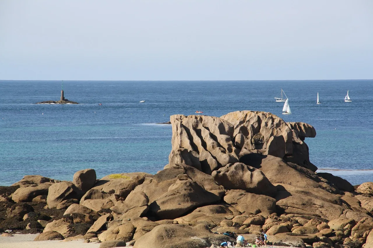 Pembe granit kıyısı ve deniz feneri manzarası