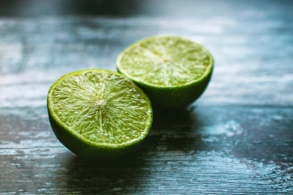 Rustik Mavi Ahşap Üzerinde Kesilmiş Taze Yeşil Limonların Makro Çekimi